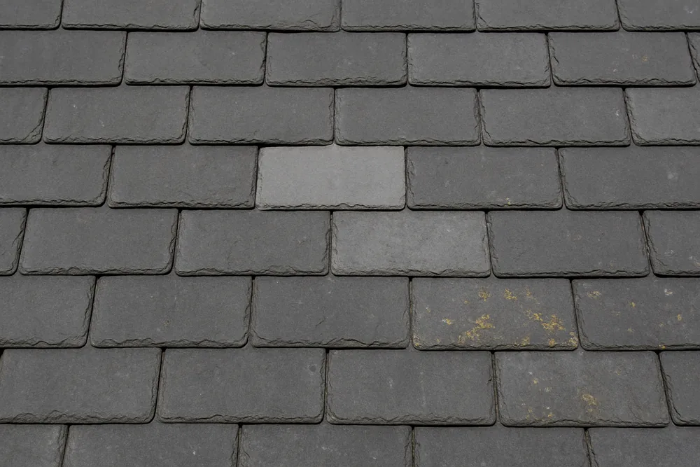Overlapping grey slates in straight courses with one slate a shade lighter than its neighbours — slate roofing, Sydney. Illustrative example.